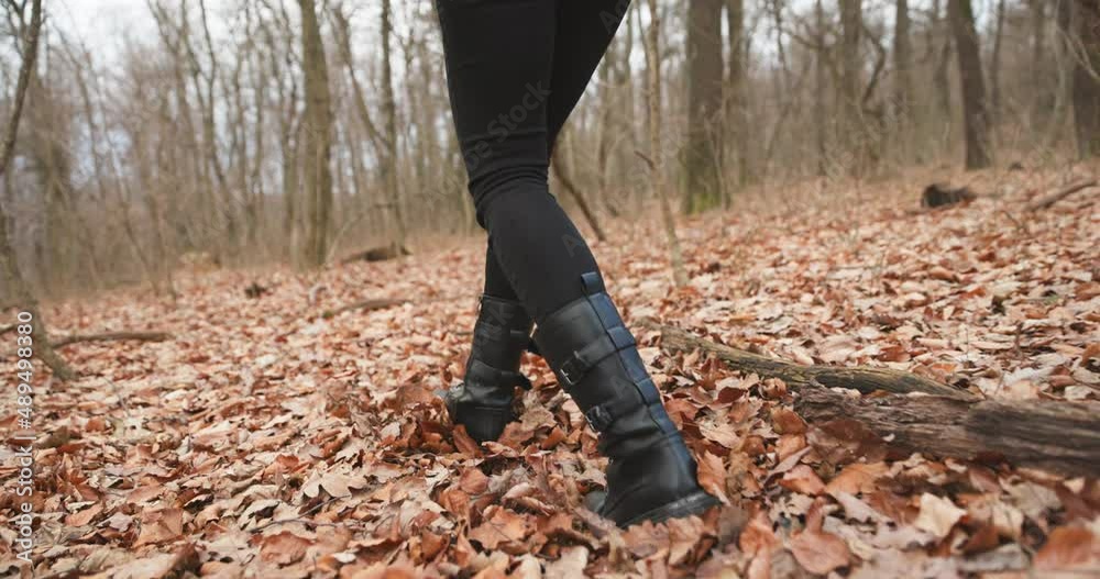 Camera following woman legs while walking in forest slow motion Camera following woman legs while walking in forest slow motion