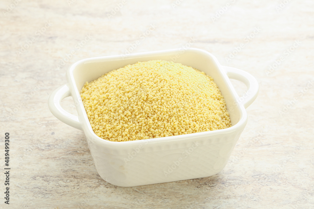 Raw couscous in the bowl Raw couscous in the bowl