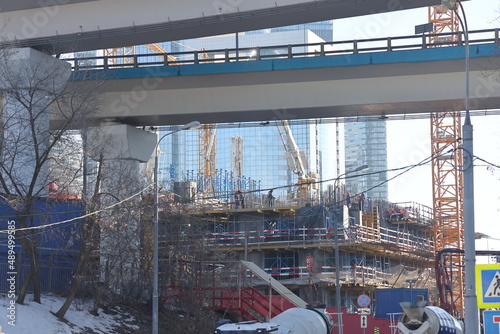 Overpasses on the background of skyscrapers. Blue sky and bright sun. Transport interchanges and urbanism. photo