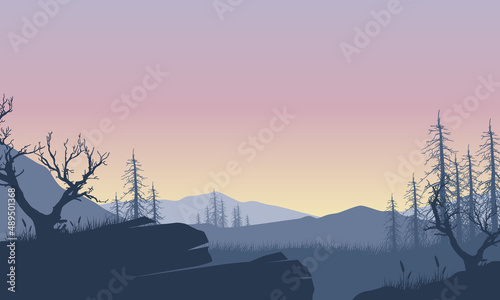 Stunning mountain view with dry tree silhouette of the village at dusk