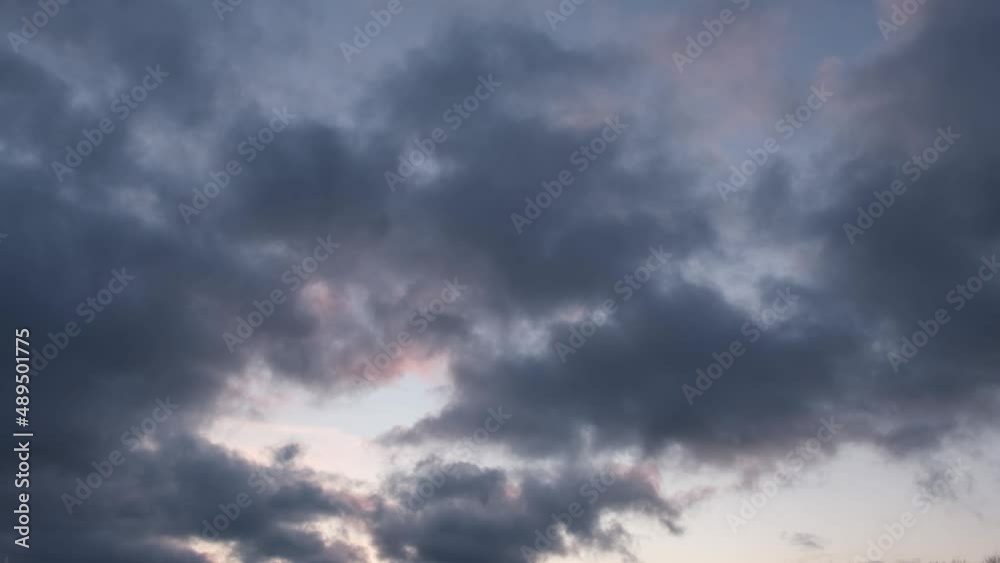 Blue clouds background. Solid cloud cover. Beautiful purple-pink color of the sky at sunset. Abstract natural background. The concept of freedom, independence, flight. Look up from the bottom Blue clouds background. Solid cloud cover. Beautiful purple-pink color of the sky at sunset. Abstract natural background. The concept of freedom, independence, flight. Look up from the bottom