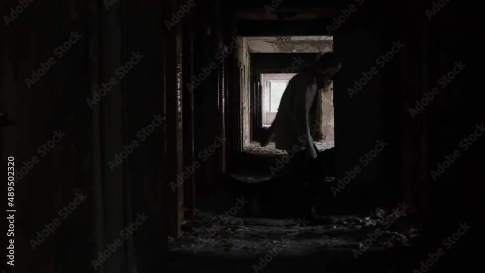 young man running in long corridor and entrances of an old abandoned building. Slow motion video. The concept of loneliness, labyrinths of fate, search for answers to questions young man running in long corridor and entrances of an old abandoned building. Slow motion video. The concept of loneliness, labyrinths of fate, search for answers to questions