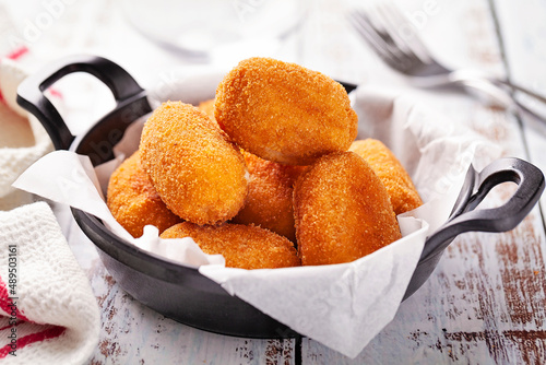 Tapa of croquettes on white table photo