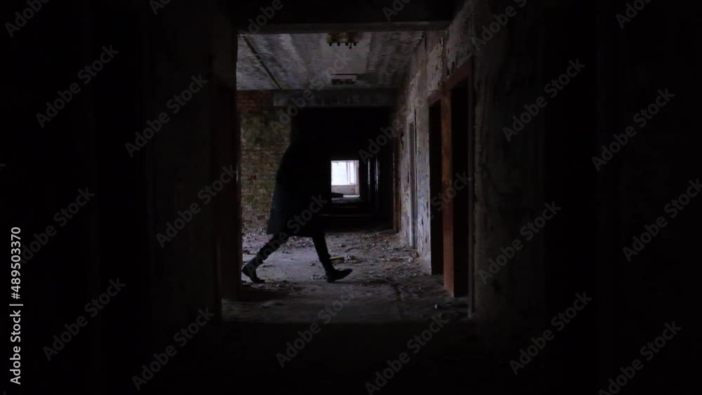 young man running in long corridor and entrances of an old abandoned building. Slow motion video. The concept of loneliness, labyrinths of fate, search for answers to questions young man running in long corridor and entrances of an old abandoned building. Slow motion video. The concept of loneliness, labyrinths of fate, search for answers to questions