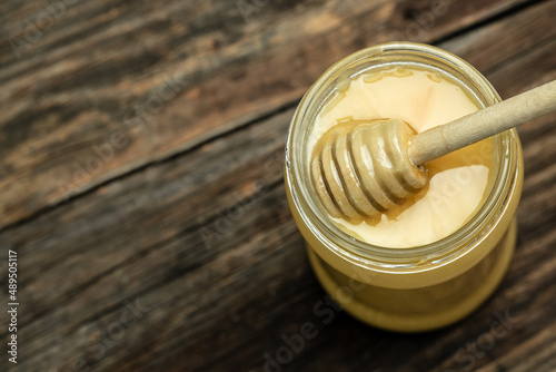 Honey in a pot or jar on kitchen table, top view