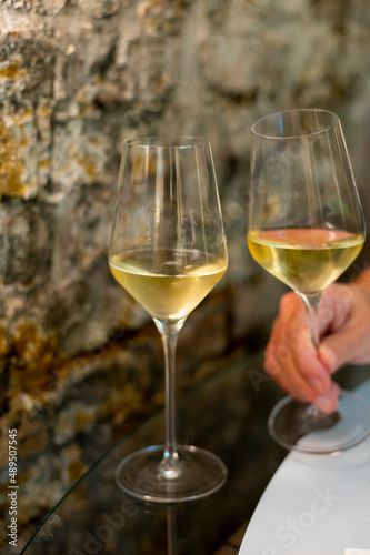 Tasting of brut champagne sparkling wine produced by traditional method in underground caves