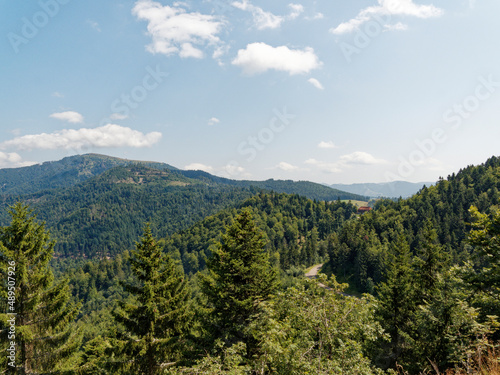 Black Forest landscapes in Southern Germany. View of Forested mountains, pastures in Münstertal valley and bare dome of Belchen peak vom nature reserve of Nonnenmattweiher 
