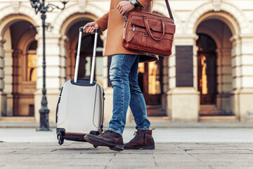 Close up of man carrying suitcase
