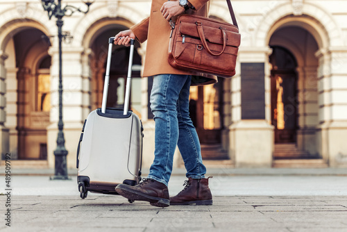 Close up of man carrying suitcase photo