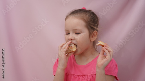 little girl eating a cinnabon bun
