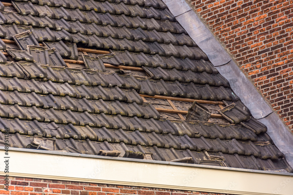 Damage to the roof from storm Eunice. Some roof tiles have been blown off the roof