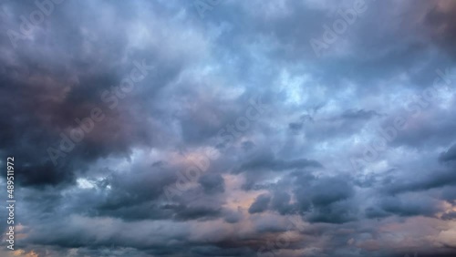 4k time lapse. Rolling dark clouds in the blue sky. Black clouds landscapes at sunset.