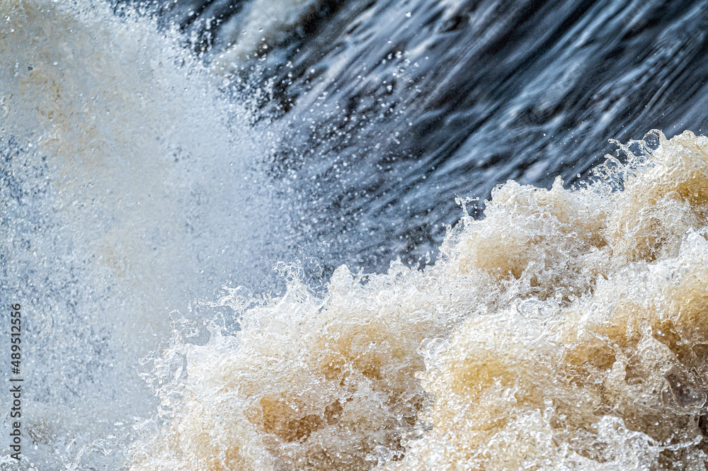 close up of flowing water, rapid water splashes of an white water river or stream, bubbly water close up of flowing water, rapid water splashes of an white water river or stream, bubbly water