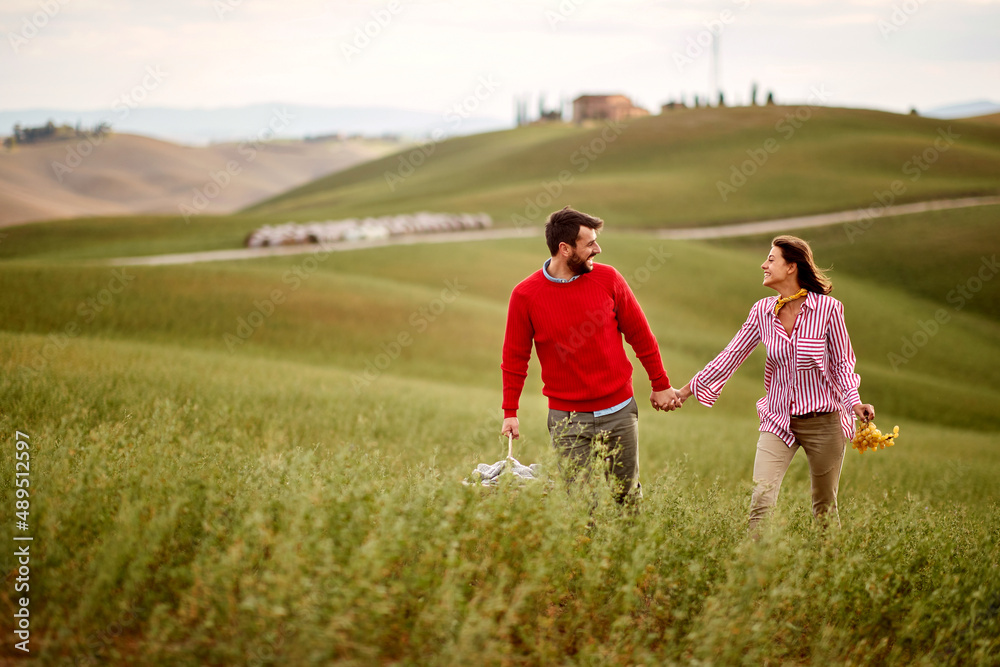 Couple walking in nature holding hands