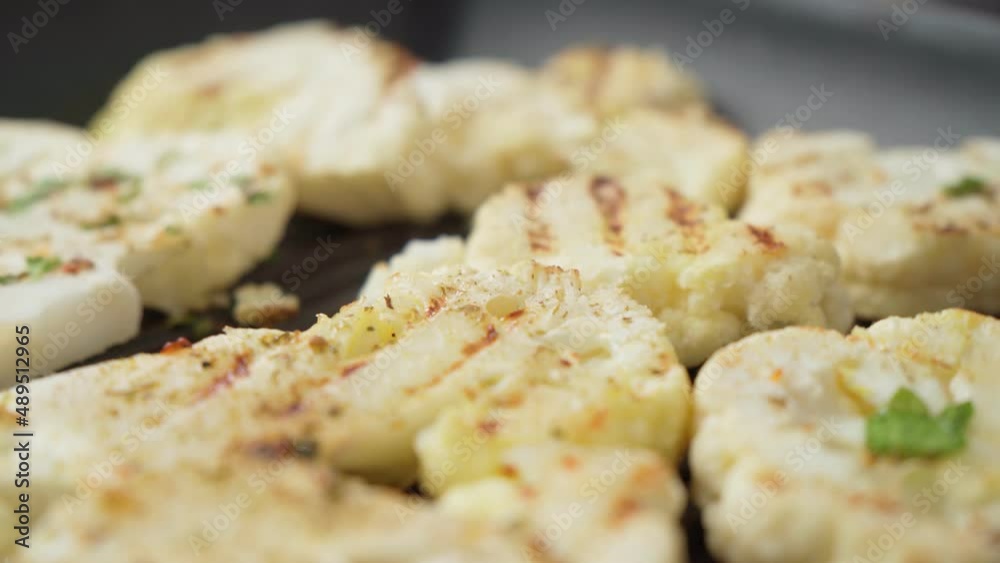 Cauliflower steak with spices cooked in pan. Vegetable meat substitute. Cauliflower steak with spices cooked in pan. Vegetable meat substitute.