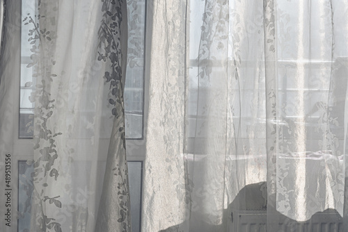 Thin white transparent curtain hanging on window at early morning in bedroom front view © Bonsales