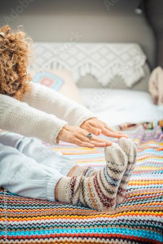 Adult woman doing sport healthy exercise inside camper van bedroom. Health and good lifestyle female people. Stretching and workout indoor at home concept.