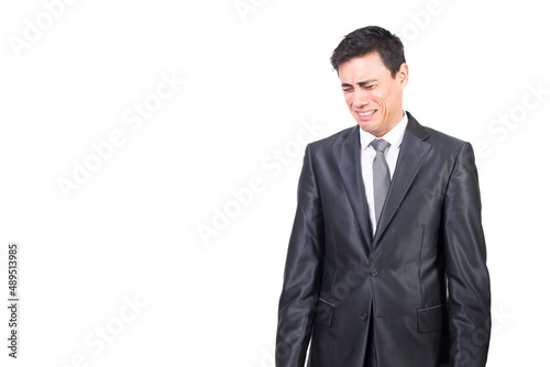 Upset man in elegant suit crying in studio
