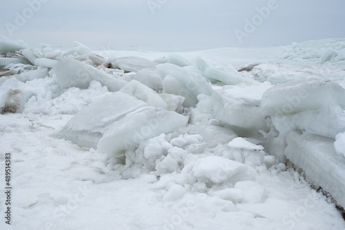 Frozen sea. Huge broken ice blocks stacked up on coast. Stormy weather in Pärnu beach.