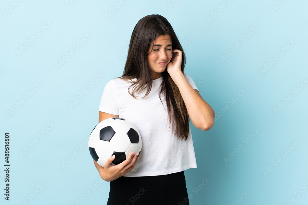 Young football player brazilian girl isolated on blue background frustrated and covering ears Young football player brazilian girl isolated on blue background frustrated and covering ears
