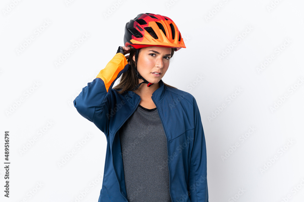 Young cyclist brazilian girl isolated on white background having doubts Young cyclist brazilian girl isolated on white background having doubts