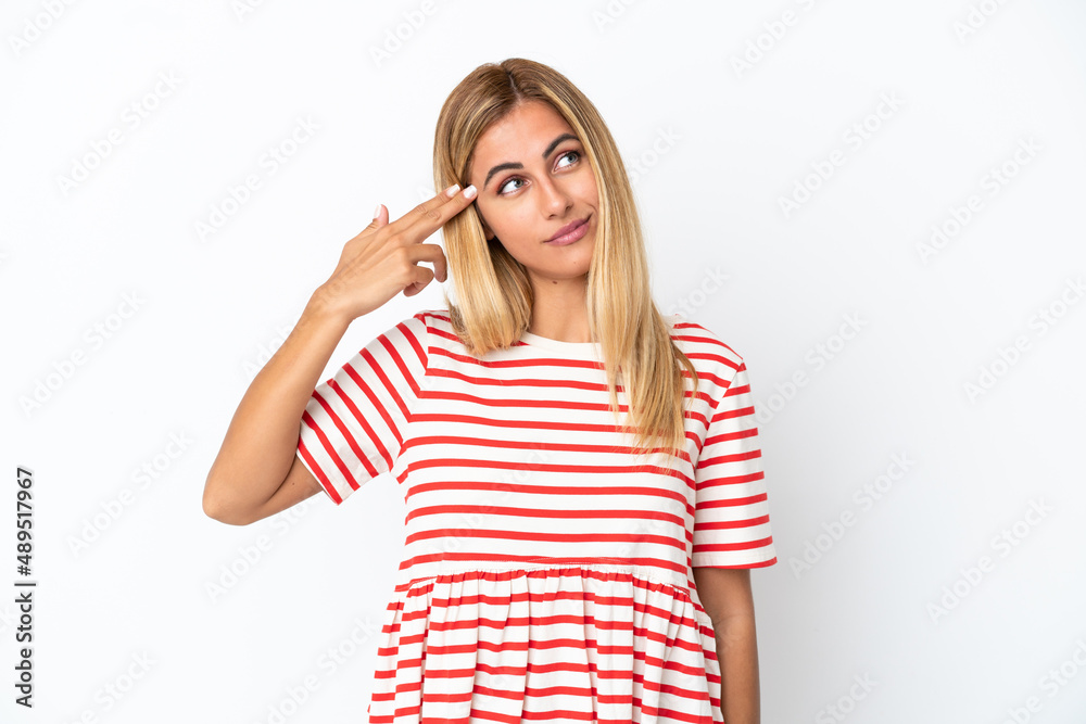 Blonde Uruguayan girl isolated on white background with problems making suicide gesture