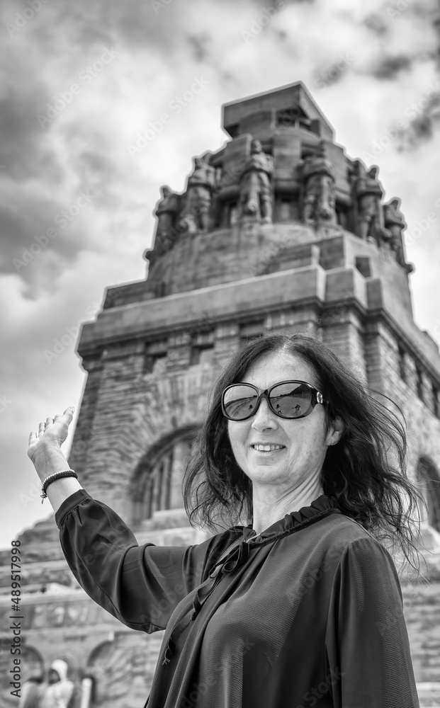 Happy woman visiting Monument to the Battle of the Nations in Leipzig.