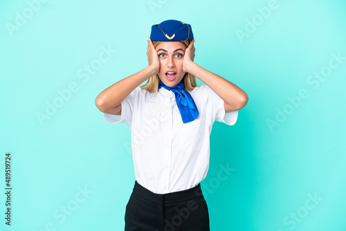 Airplane stewardess Uruguayan woman isolated on blue background with surprise expression