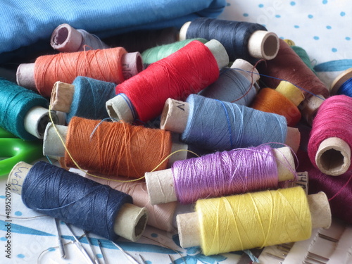 Pile of spools of thread of different colors. Multicolored threads for sewing.