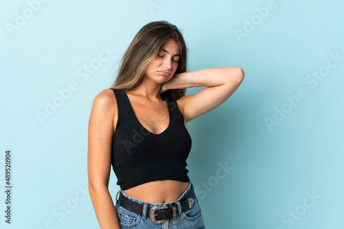 Young caucasian woman isolated on blue background with neckache