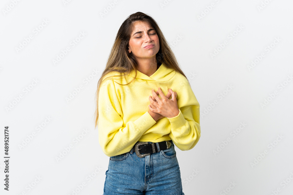 Young caucasian woman isolated on white background having a pain in the heart Young caucasian woman isolated on white background having a pain in the heart
