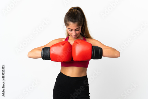 Young caucasian woman isolated on white background with boxing gloves © luismolinero