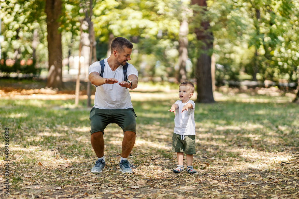 Father teaching son exercises in nature. Father teaching son exercises in nature.