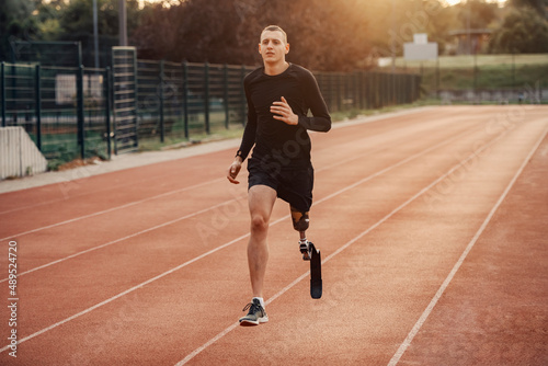 A fast runner with artificial leg running at the stadium.