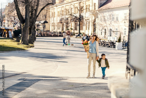 A mother going for a walk with son on a mother's day.