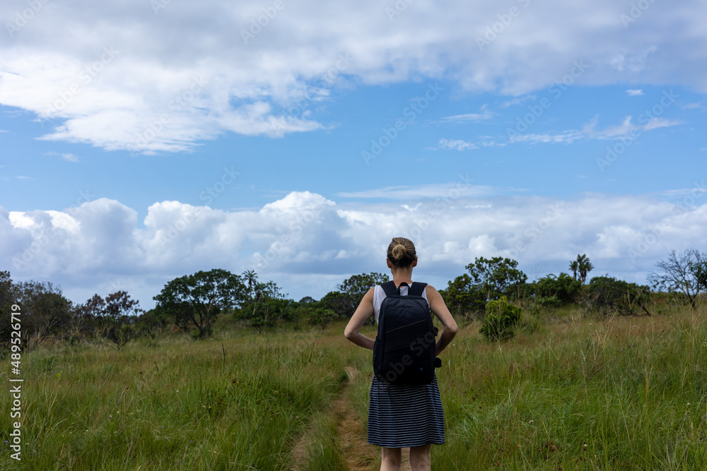 woman on hiking trail, with back pack, looking at a storm woman on hiking trail, with back pack, looking at a storm