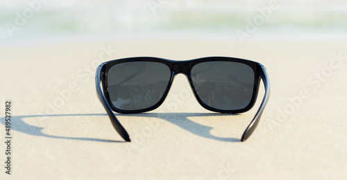 Sunglasses on sand beautiful summer beach copy space Holiday concept.