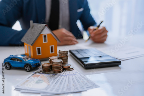 Real estate broker agent being analysis and making the decision a home estate loan to the customer to signing contract documents for realty purchase, Bank employees recommend mortgage loan approval.