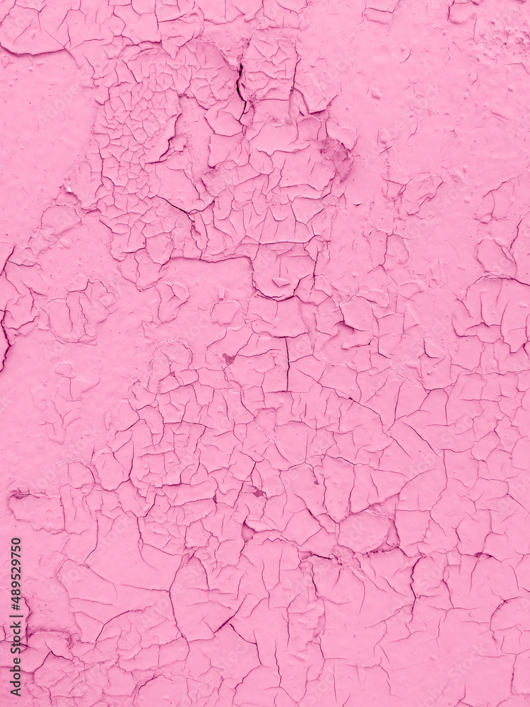 Cracked pink paint on the wall as an abstract background.