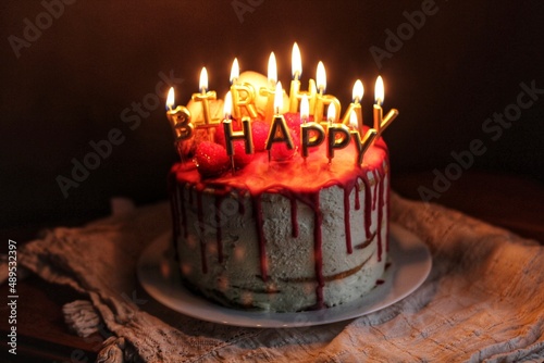 Cake with cream cheese, macaroons ans raspberries with candeles isolated photo