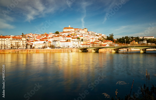 Panorama of the city of Coimbra at the golden hour. View of the left bank of the Mondego River. 