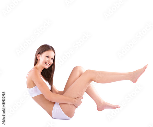 That is smooth.... Full body studio shot of a young woman caressing her bare leg.