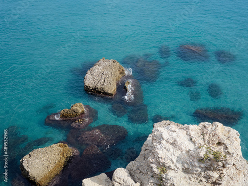 Crystalline water and rocks in Calahonda beach, in the Mediterranean sea. Nerja, province of Málaga, Costa del Sol, Andalusia, Spain. Turquoise clean water background