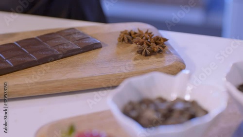Crush and cut chocolate on the wooden board.