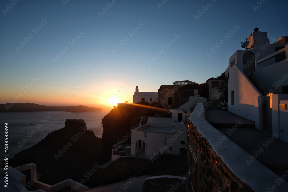 Rays of light just before the sun is setting at the famous village of Firostefani Santorini