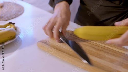 Peeling and cutting bananas on the wooden board