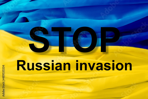 The inscription in large letters STOP russian invasion on the Ukrainian flag photo