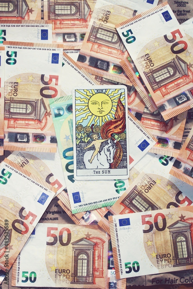 Euro banknotes and Sun tarot card