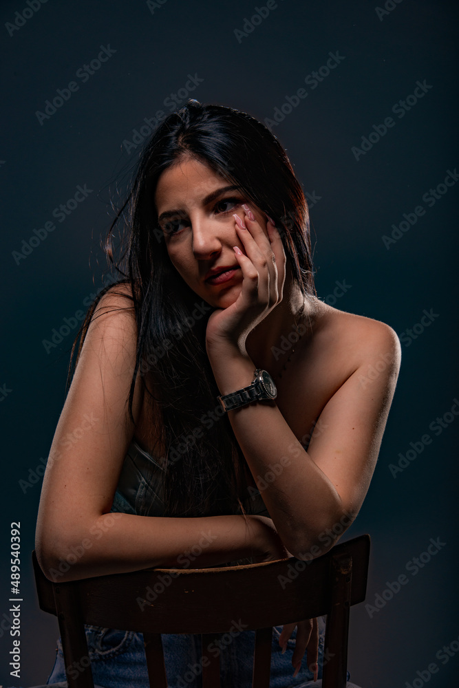 Posing while thinking and leaning on her arm Posing while thinking and leaning on her arm