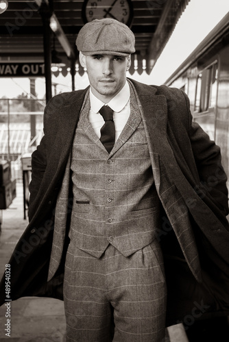 Photography Action shot of handsome English male gangster at train station looking at camera
